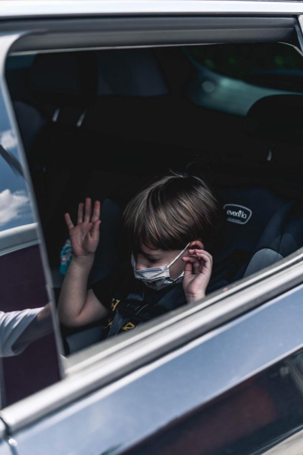 A child alone in a car unsupervised.